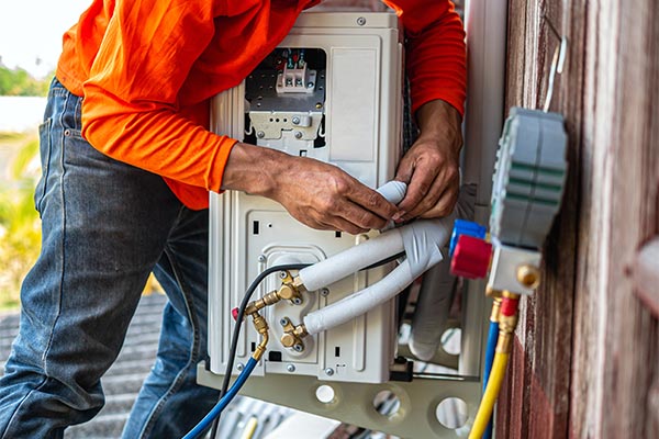 tech performing maintenance on unit